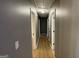 A long hallway with gray walls and wood floors with doors on either side at 4710 Cedar Brook Se Dr, Conyers, GA 30094