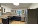 Kitchen with white and blue cabinets, granite countertops, and stainless steel appliances, radiating modern charm at 4710 Cedar Brook Se Dr, Conyers, GA 30094