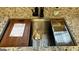 Close up shot of a stainless steel kitchen sink with a wood cutting board and colander at 4710 Cedar Brook Se Dr, Conyers, GA 30094