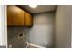 A gray walled laundry room with tan cabinets and new, light colored vinyl flooring at 4710 Cedar Brook Se Dr, Conyers, GA 30094