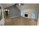 Bright living room with a fireplace, large windows, and wood flooring at 4710 Cedar Brook Se Dr, Conyers, GA 30094