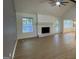 Bright living room with a fireplace, large windows, and wood flooring at 4710 Cedar Brook Se Dr, Conyers, GA 30094