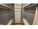Walk-in closet with custom shelving and built in benches at 4710 Cedar Brook Se Dr, Conyers, GA 30094