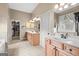 Bright bathroom featuring double vanities, a closet, and natural light from a window at 9360 Ward Rd, Winston, GA 30187