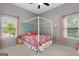 Bright bedroom with canopy bed, carpeted floors, and natural light from windows at 9360 Ward Rd, Winston, GA 30187