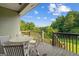 Outdoor deck features wood railing, seating, and lush green scenery at 9360 Ward Rd, Winston, GA 30187