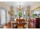 Inviting dining room with a large window and a classic chandelier provides an elegant space for Gathering dinners at 9360 Ward Rd, Winston, GA 30187