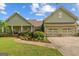 Inviting home with an attached two-car garage and a beautifully landscaped front yard and walkway at 9360 Ward Rd, Winston, GA 30187