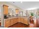 Well-equipped kitchen with wood cabinets, tile backsplash, and an open layout for easy meal preparation at 9360 Ward Rd, Winston, GA 30187