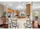 Bright kitchen features wooden cabinetry, granite countertops, and bar seating for casual meals at 9360 Ward Rd, Winston, GA 30187