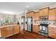 Modern kitchen with stainless steel appliances, wooden cabinets, and an island for food prep and dining at 9360 Ward Rd, Winston, GA 30187