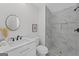 Modern bathroom with a marble shower, white vanity, and a round mirror at 101 Fairfield Nw Pl, Atlanta, GA 30314