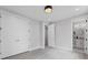 Bedroom with closet, white doors, grey floor and showing view into an attached bathroom at 101 Fairfield Nw Pl, Atlanta, GA 30314