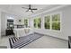 Bright bedroom with large windows, tray ceiling, ceiling fan and an eye-catching navy rug at 101 Fairfield Nw Pl, Atlanta, GA 30314
