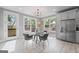 Bright dining room with a glass table, modern chairs, gray cabinets, and stainless steel refrigerator at 101 Fairfield Nw Pl, Atlanta, GA 30314
