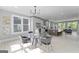 Dining area showcasing a glass table, modern chairs, and an open view of the modern kitchen at 101 Fairfield Nw Pl, Atlanta, GA 30314