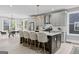 Modern kitchen featuring gray cabinets, a spacious island with seating, and stainless steel appliances, open to the dining room at 101 Fairfield Nw Pl, Atlanta, GA 30314