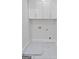 The laundry room features tile floors, hook ups, and white storage cabinets at 101 Fairfield Nw Pl, Atlanta, GA 30314