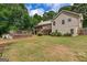 Large backyard with a wooden deck, mature trees, and lawn at 116 Alexander Dr, Mcdonough, GA 30252