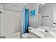 Clean bathroom featuring a shower-tub combo with blue curtain and white fixtures at 116 Alexander Dr, Mcdonough, GA 30252