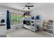 Bedroom with a bunk bed, large window, and a ceiling fan at 116 Alexander Dr, Mcdonough, GA 30252