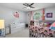 Brightly lit bedroom with a ceiling fan and a window allowing natural light at 116 Alexander Dr, Mcdonough, GA 30252