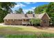 Charming brick home with dormer windows, mature trees, and a well-maintained front lawn at 116 Alexander Dr, Mcdonough, GA 30252