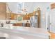 Kitchen with wood cabinets, stainless steel appliances, and white countertop at 116 Alexander Dr, Mcdonough, GA 30252