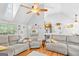 Open living room with vaulted ceilings, wood floors, and an open floor plan to the kitchen at 116 Alexander Dr, Mcdonough, GA 30252