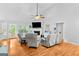 Bright living room with fireplace, wood floors, and views of the backyard at 116 Alexander Dr, Mcdonough, GA 30252
