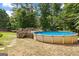 Backyard features an above ground pool with wooden deck and surrounding mature trees at 116 Alexander Dr, Mcdonough, GA 30252