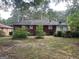 View of the home's backyard showing the exterior and surrounding greenery at 24 Mobley Se Dr, Atlanta, GA 30315