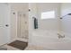 Bathroom with a bathtub and a shower, featuring tile flooring and neutral walls at 170 Saddleridge Dr, Bremen, GA 30110