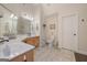 Bathroom featuring double sinks, tile flooring, and a white toilet and door at 170 Saddleridge Dr, Bremen, GA 30110