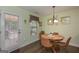 Bright dining area featuring a round table, modern chairs, and an outdoor door at 170 Saddleridge Dr, Bremen, GA 30110