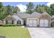 Charming home featuring a well-manicured lawn, stone accents, and a two-car garage at 170 Saddleridge Dr, Bremen, GA 30110