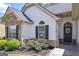 Beautiful entryway featuring a decorative door with a floral wreath and landscaped flower bed at 170 Saddleridge Dr, Bremen, GA 30110