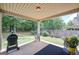 Covered patio space featuring a grill, a chair, and a view of the backyard at 170 Saddleridge Dr, Bremen, GA 30110