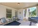 Covered patio space with seating, grill, and an entrance to the backyard at 170 Saddleridge Dr, Bremen, GA 30110
