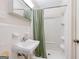This bathroom features a tile surround, a sink and an all-in-one shower at 741 Greenhill Ne Dr, Conyers, GA 30012