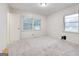 Neutral bedroom with bright white walls, carpet flooring, and double windows at 741 Greenhill Ne Dr, Conyers, GA 30012
