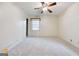 Bright bedroom featuring carpet, ceiling fan, and natural light from the windows at 741 Greenhill Ne Dr, Conyers, GA 30012