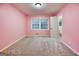 This bedroom is spacious and bright from the large window at 741 Greenhill Ne Dr, Conyers, GA 30012