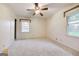 Bright bedroom with carpeting, ceiling fan, and natural light from two windows at 741 Greenhill Ne Dr, Conyers, GA 30012