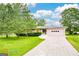 Charming single-story home with a well-manicured lawn, a long driveway, and an attached three-car garage at 741 Greenhill Ne Dr, Conyers, GA 30012