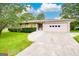 Charming single-story home featuring lush landscaping, driveway, and an attached three-car garage at 741 Greenhill Ne Dr, Conyers, GA 30012