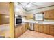 Cozy kitchen with wood cabinets, stainless steel appliances and views to another room at 741 Greenhill Ne Dr, Conyers, GA 30012