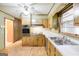 Cozy kitchen with wood cabinets, updated appliances and views to a back hallway and into a separate dining room at 741 Greenhill Ne Dr, Conyers, GA 30012