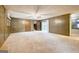 Expansive living room with wood paneling, ceiling fan, and access to a closet and backyard at 741 Greenhill Ne Dr, Conyers, GA 30012