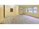 Bright living room with neutral carpet, windows, and ceiling light, creates a welcoming and spacious ambiance at 741 Greenhill Ne Dr, Conyers, GA 30012
